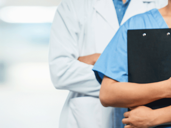 Medical Professionals standing next to each other in a doctors office